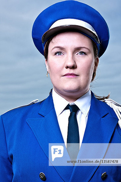 Portrait of young woman wearing marching band uniform