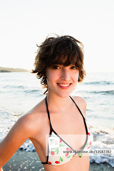 Woman smiling in bikini on beach