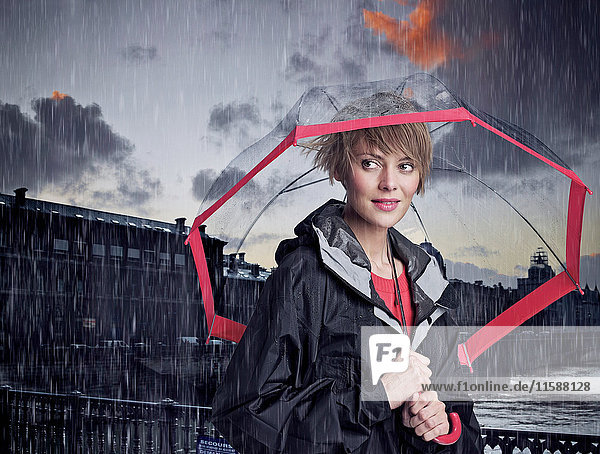 Woman walking under umbrella in rain