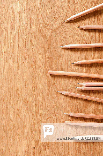 Wooden pencils on wooden background