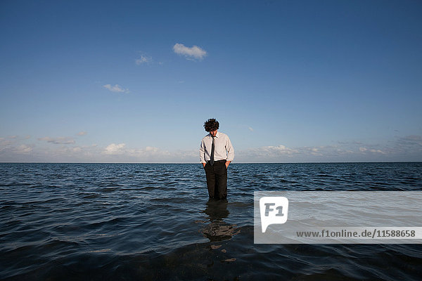Businessman standing in sea