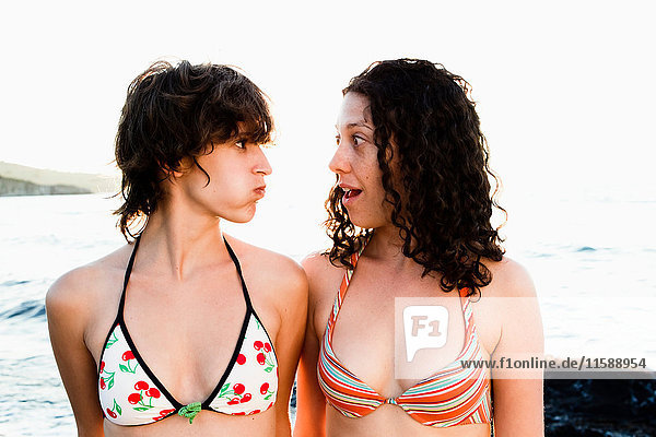 Women wearing bikinis on beach