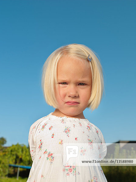 Young girl frowning outside  portrait