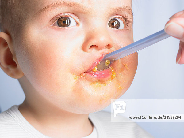 Portrait of a baby boy eating
