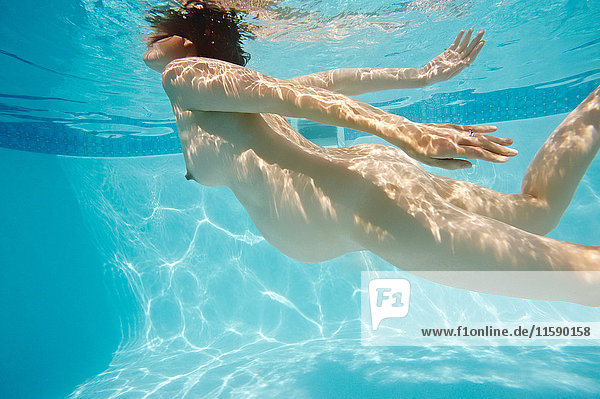 Pregnant woman swimming in pool