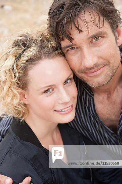 couple embracing smiling at viewer