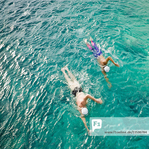Men swimming in sea