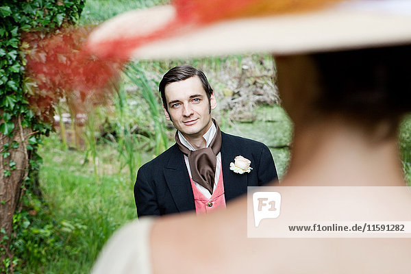 Bridal couple in 1920s style clothing  groom looking at bride