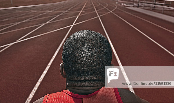Male athlete staring down running track