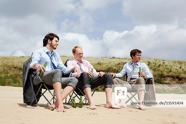 Businessmen relaxing on beach