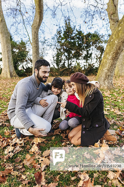 Happy family in autumnal park