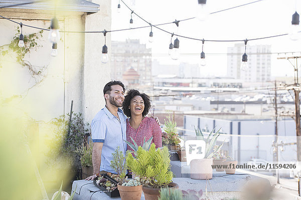 Couple standing in their rooftop garden