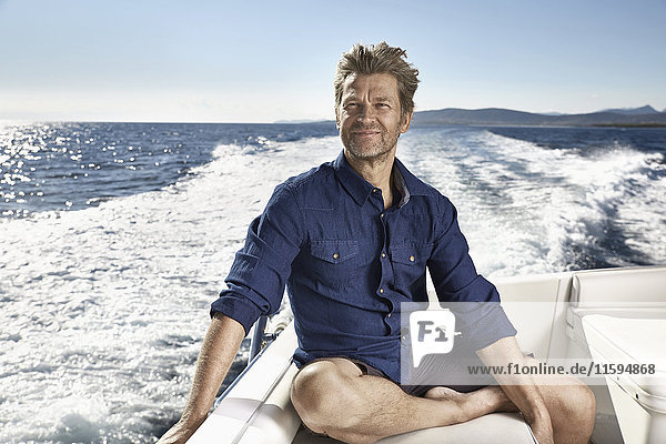 Portrait of content mature man on his motor yacht