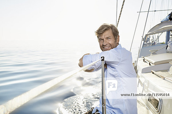 Portrait of smiling mature man on his sailing boat