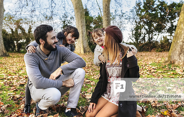 Happy family together in autumnal park