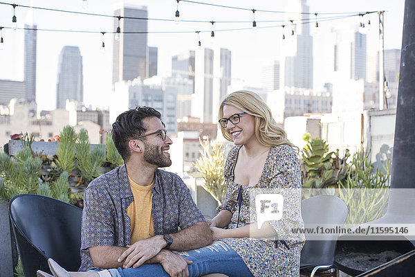 Couple sitting on rooftop terrace