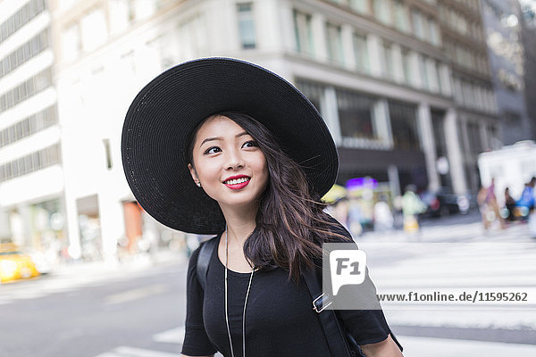 USA  New York City  Manhattan  portrait of fashionable young woman wearing black hat