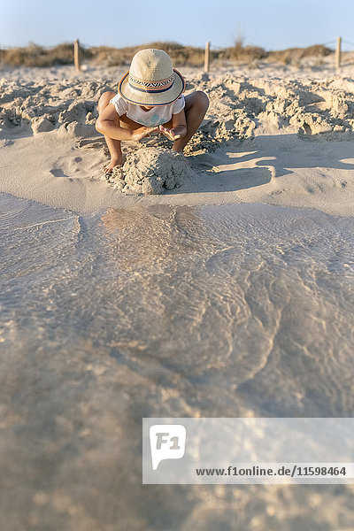 Spain  Menorca  little girl playing on the beach