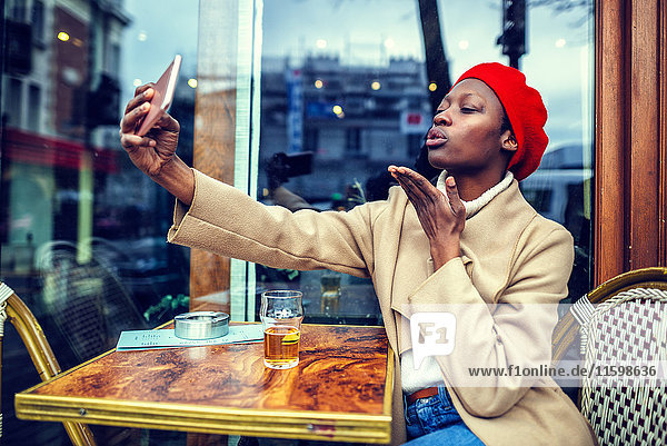 Young woman in Paris taking a selfie