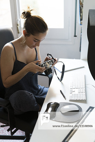 Female photographer editing images at desk