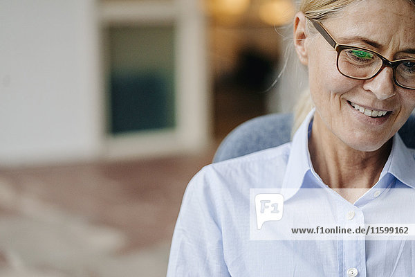 Portrait of smiling businesswoman wearing glasses