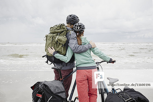 Germany  Schleswig-Holstein  St Peter-Ording  couple with bicycles on the beach