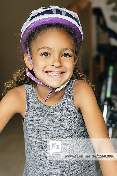 Portrait of smiling Mixed Race girl wearing helmet