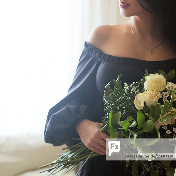 Caucasian woman holding roses