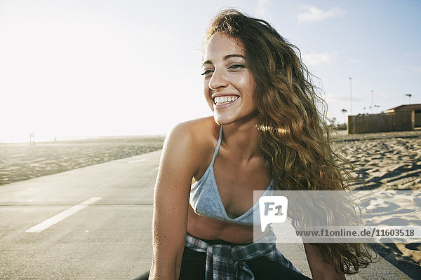 Portrait of Caucasian woman smiling on path at beach