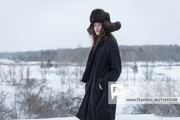 Serious Caucasian woman wearing fur hat and coat in winter