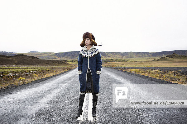 Caucasian woman standing in middle of road