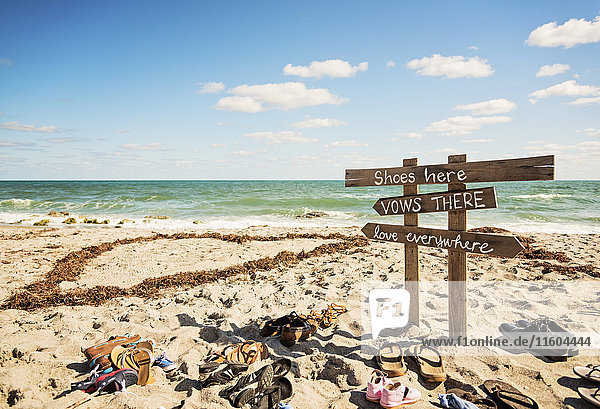 Shoes and signs for wedding on ocean beach