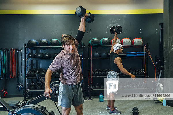 Men lifting weights in gymnasium