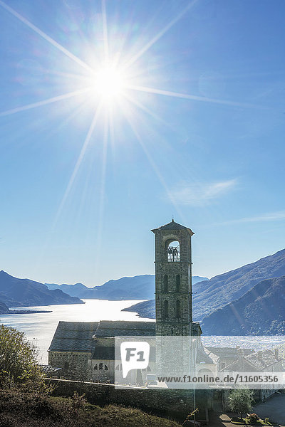 Sun in blue sky over Gravedona Lake Como Italy