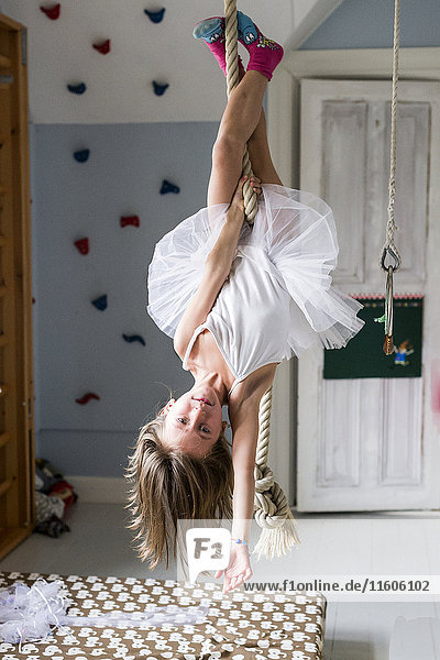 Girl hanging upside down