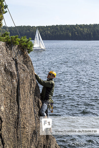 Man climbing cliff