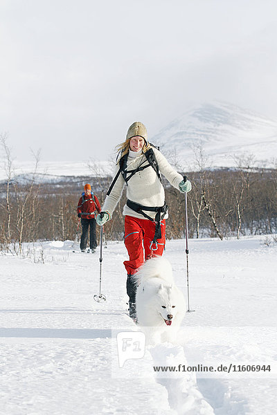 Smiling woman cross-country skiing