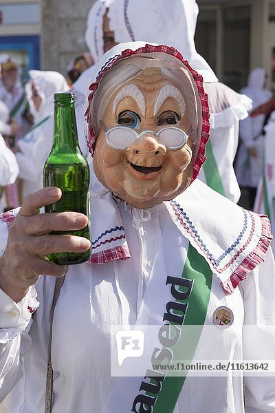 Ausseer Fasching  Mann mit Maske  weißes Gewand  Trommelweib  mit Flasche in der Hand  Bad Aussee  Steiermark  Österreich  Europa