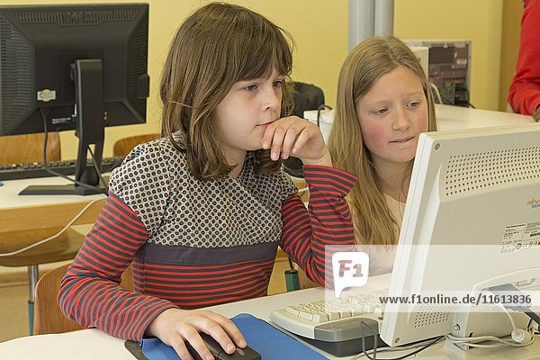 Elementary school girls working in computer room  Lower Saxony  Germany  Europe