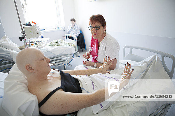 Reportage in der onkologischen Abteilung einer Tagesklinik in Frankreich. Die Hilfskrankenschwester Marie-Cécile arbeitet hier drei Tage in der Woche als Krankenhauskosmetikerin. Sie bietet krebskranken Frauen Schönheitsbehandlungen und Lösungen zur Bewältigung der Nebenwirkungen von Krebsbehandlungen an. Diese Momente eignen sich gut für persönliche Gespräche. Sie gibt einer Patientin eine Schönheitsbehandlung während einer Chemotherapie.