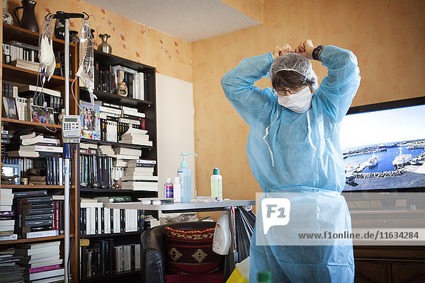Reportage über einen häuslichen Pflegedienst in Savoie  Frankreich. Eine Krankenschwester bereitet sich darauf vor  den Chemotherapie-Tropf eines Krebspatienten zu wechseln.