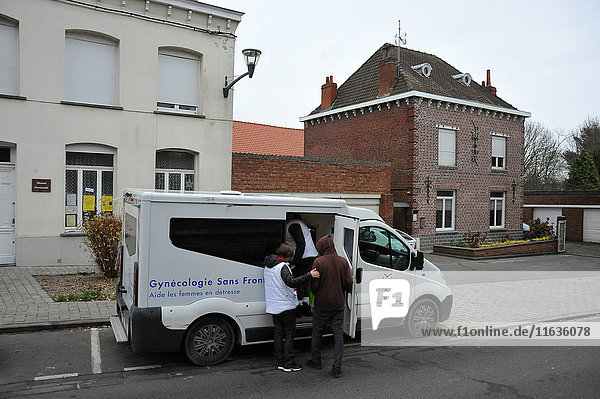 Reportage on volunteers with the French charity  Gynecologists Without Borders who work in refugee camps near Calais in the north of France. A van in front of Steenvoorde church hall  a day-care centre.