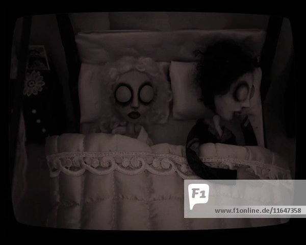 Puppenfiguren einer Frau  die mitten in der Nacht aus dem Bett steigt  während der Mann schläft  Stop-Motion-Effekt