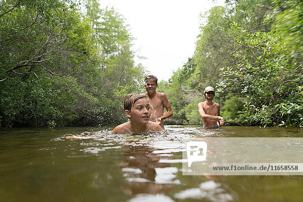 Teenage boys swimming in lake  Niceville  Florida  USA