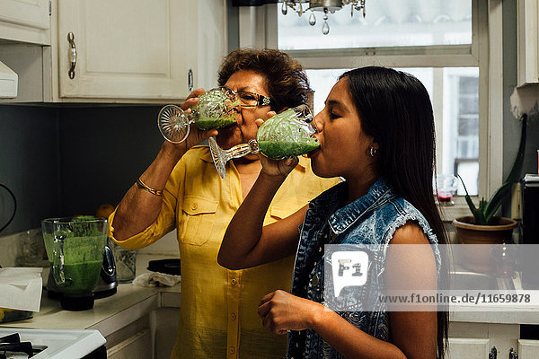 Großmutter und Enkelin trinken Smoothies