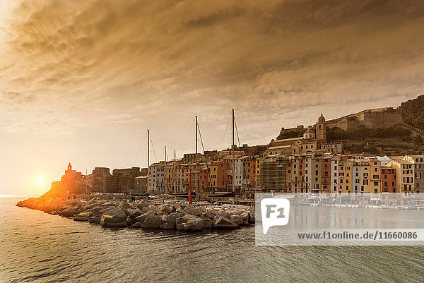 View of harbour and Church of St Peter on headland at sunset  Porto Venere  Liguria  Italy