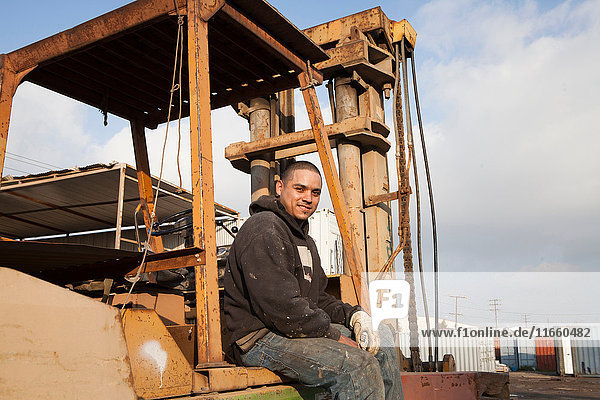 Mann auf der Baustelle auf schweren Maschinen sitzend