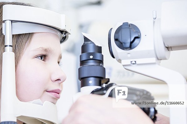 Girl patient having eye examination in optometrist's shop  close-up.