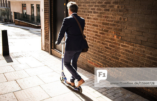 Businessman on scooter  London  UK
