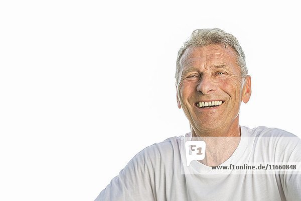 Senior man smiling against white background  portrait.